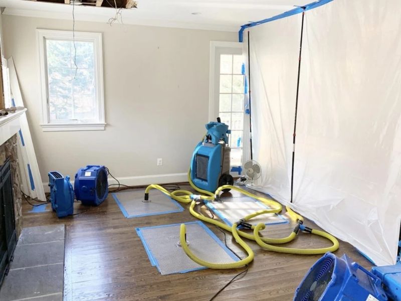 Water damage restoration drying equipment and air movers drying a flooded room in Orlando FL