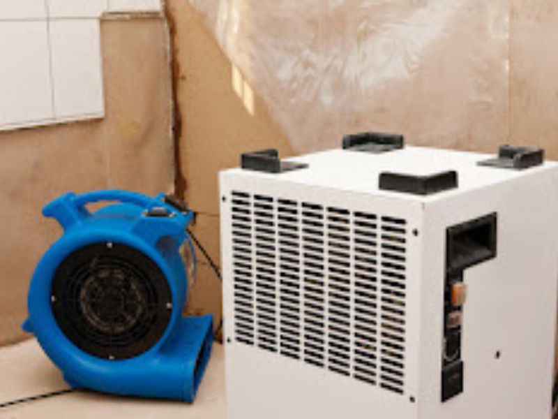 Water damage restoration drying equipment removing moisture from walls in Orlando FL