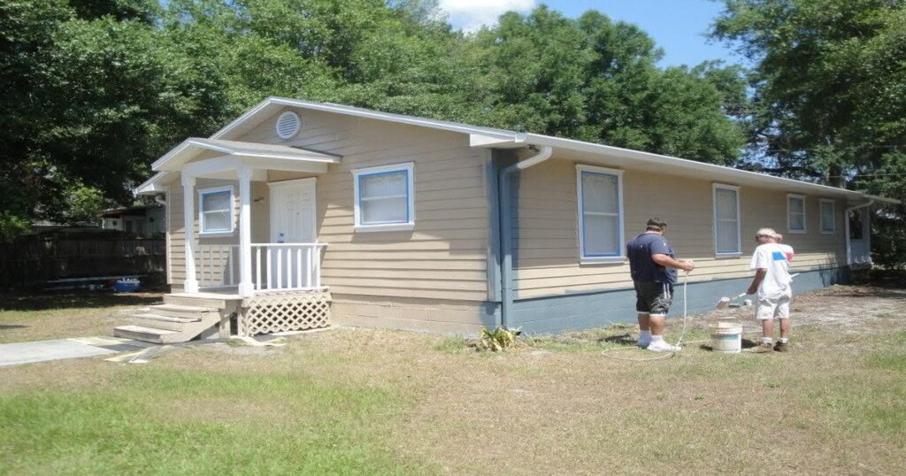 Orlando stucco home being painted on a clear morning